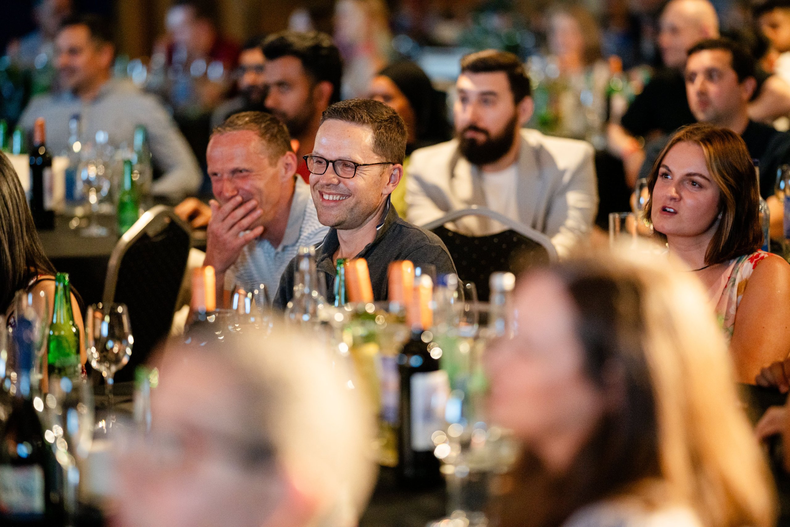 People at a social gathering, smiling and engaged.