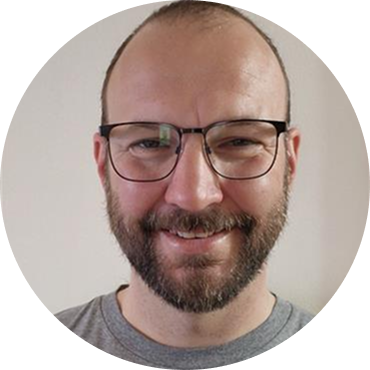 Portrait of a man with glasses and a beard.
